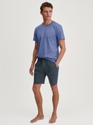 Men model is wearing Short-sleeved shirt made of 100% Cotton in Blue, Unicoloured from the Remix Basic Sleep series by CALIDA, Outfit