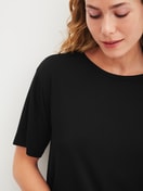Women model is wearing Shirt short sleeve made of Modal in Black, Unicoloured from the Favourites Layering series by CALIDA, Detail