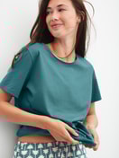 Women model is wearing Shirt short sleeve made of 100% Cotton in Turquoise, Unicoloured from the Favourites Beach series by CALIDA, Additional Image