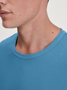 Men model is wearing Shirt long sleeve made of 100% Cotton in Blue, Unicoloured from the RMX Sleep Leisure series by CALIDA, Detail