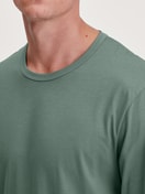 Men model is wearing Shirt long sleeve made of 100% Cotton in Green, Unicoloured from the RMX Sleep Weekend series by CALIDA, Detail
