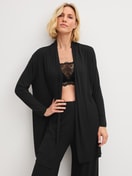Women model is wearing Kimono made from TENCEL™ Modal made of Modal in Black, Unicoloured from the Feminine Lounge series by CALIDA, Front view