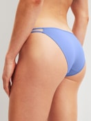 Women model is wearing Low Cut Tanga Brief made of Polyamide in Blue, Unicoloured from the Sleek Skin series by CALIDA, Back view