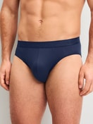 Men model is wearing Brief made of Lyocell in Blue, Unicoloured from the Natural Cooling series by CALIDA, Front view