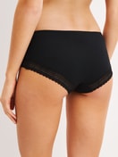 Women model is wearing Shorty made of Modal in Black, Unicoloured from the Etude Ajours series by CALIDA, Back view