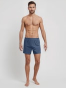 Herren-Model trägt Boxershorts, 2er-Pack aus 100% Baumwolle in Blau, Gemustert aus Serie Daywear Xtra von CALIDA, Outfit