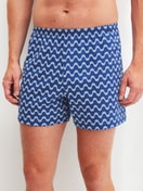 Men model is wearing Boxer shorts made of Cotton in Blue, Patterned from the Prints series by CALIDA, Front view