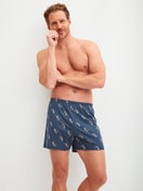 Men model is wearing Boxer shorts made of Cotton in Blue, Patterned from the Prints series by CALIDA, Outfit