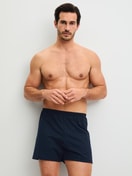 Men model is wearing Boxer shorts made of 100% Cotton in Blue, Patterned from the Prints series by CALIDA, Outfit