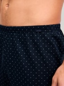 Men model is wearing Boxer shorts made of 100% Cotton in Blue, Patterned from the Prints series by CALIDA, Detail