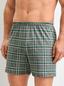 Men model is wearing Boxer shorts made of 100% Cotton in Green, Checked from the Prints series by CALIDA, Front view
