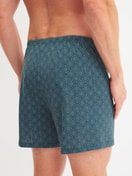 Herren-Model trägt Jersey-Boxershorts ohne Eingriff aus Baumwolle in Blau, Gemustert aus Serie Prints von CALIDA, Rückansicht