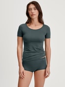 Women model is wearing Shorty regular cut made of Cotton in Green, Unicoloured from the Natural Comfort series by CALIDA, Outfit