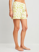 La modella / Il modello Donna indossa Pantaloni corti del pigiama in 100% cotone di colore Verde, Floreale, della serie Late Bloom M&M di CALIDA, Vista frontale