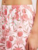 Women model is wearing Pyjama shorts made of 100% Cotton in Orange, Floral from the Favourites Beach series by CALIDA, Detail