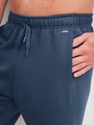Men model is wearing Bermudas with side pockets made of Cotton in Blue, Unicoloured from the RMX Lounge Journey series by CALIDA, Detail