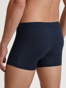 Men model is wearing Boxerbrief made of TENCEL™ in Blue, Unicoloured from the Balanced Day series by CALIDA, Back view