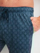 Men model is wearing Bermudas made of 100% Cotton in Turquoise, Patterned from the RMX Sleep Leisure series by CALIDA, Detail