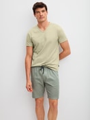 Men model is wearing Bermudas made of 100% Cotton in Green, Unicoloured from the RMX Sleep Leisure series by CALIDA, Outfit