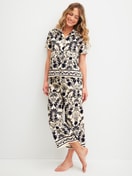 Women model is wearing 7/8 pyjama trousers made of 100% Cotton in Beige, Floral from the Favourites Layering series by CALIDA, Outfit