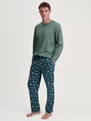 Herren-Model trägt Pyjamahose mit Seitentaschen aus 100% Baumwolle in Grün, Gemustert aus Serie RMX Sleep Weekend von CALIDA, Outfit