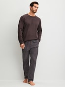 Men model is wearing Pyjama Bottoms with Side Pockets made of 100% Cotton in Brown, Striped from the RMX Sleep Weekend series by CALIDA, Outfit