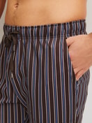 Men model is wearing Pyjama Bottoms with Side Pockets made of 100% Cotton in Brown, Striped from the RMX Sleep Weekend series by CALIDA, Detail