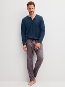 Herren-Model trägt Pyjamahose mit Seitentaschen aus Baumwolle in Braun, Gestreift aus Serie RMX Sleep Superlight von CALIDA, Outfit