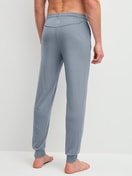 Men model is wearing Pyjama bottom with cuffs made of Lyocell in Grey, Unicoloured from the DSW Warming series by CALIDA, Back view