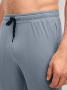 Men model is wearing Pyjama bottom with cuffs made of Lyocell in Grey, Unicoloured from the DSW Warming series by CALIDA, Detail