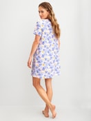 Women model is wearing Short-sleeved nightdress, length 95 cm made of 100% Cotton in Blue, Floral from the Coastal Dreams series by CALIDA, Back view