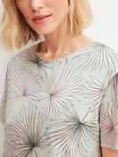 Women model is wearing Short-sleeved nightdress, length 95 cm made of 100% Cotton in Green, Floral from the Leaf Dreams series by CALIDA, Detail