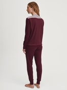 Women model is wearing Pyjama with cuff made of 100% Cotton in Red, Patterned from the Season Special series by CALIDA, Back view