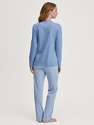 Women model is wearing Pyjamas, long made of 100% Cotton in Blue, Striped from the Midnight Stripes series by CALIDA, Back view