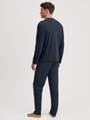 Men model is wearing Pyjamas, long made of 100% Cotton in Blue, Patterned from the Relax Streamline series by CALIDA, Back view