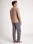 Men model is wearing Pyjamas, long made of 100% Cotton in Beige, Patterned from the Nightwear Xtra series by CALIDA, Back view
