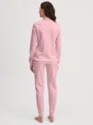 Damen-Model trägt Bündchen-Pyjama aus 100% Baumwolle in Rosa, Motiv aus Serie Ski Resort von CALIDA, Rückansicht
