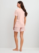 Women model is wearing Short pyjama made of 100% Cotton in Pink, Patterned from the Easter Nights series by CALIDA, Back view
