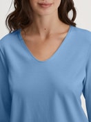 Women model is wearing Capri Pyjama made of 100% Cotton in Blue, Floral from the Flower Nights series by CALIDA, Detail