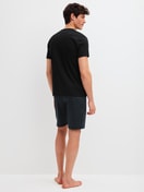 Men model is wearing Short pyjamas made of 100% Cotton in Black, Patterned from the Relax Streamline 2 series by CALIDA, Back view