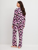 Women model is wearing Button-Up Pyjama made of 100% Cotton in Pink, Floral from the Autumn Dreams series by CALIDA, Back view