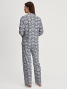 Women model is wearing Button-Up Pyjama made of 100% Cotton in Blue, Patterned from the Autumn Dreams series by CALIDA, Back view