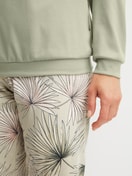 Women model is wearing Pyjama with cuff made of 100% Cotton in Green, Floral from the Leaf Dreams series by CALIDA, Detail