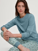 Women model is wearing Pyjama with cuff made of 100% Cotton in Blue, Patterned from the Ornament Nights series by CALIDA, Front view