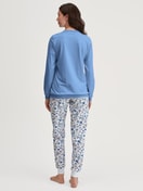 Women model is wearing Pyjama with cuff made of 100% Cotton in Blue, Floral from the Flower Nights series by CALIDA, Back view