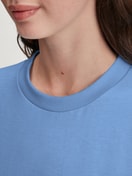 Women model is wearing Pyjama with cuff made of 100% Cotton in Blue, Floral from the Flower Nights series by CALIDA, Detail