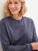 Women model is wearing Pyjama with cuff made of 100% Cotton in Blue, Patterned from the Graphic Nights series by CALIDA, Detail