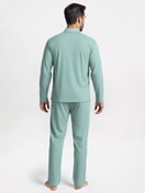 Men model is wearing Button-Up Pyjama made of 100% Cotton in Green, Striped from the Nightwear Xtra series by CALIDA, Back view