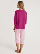 Women model is wearing Capri Pyjama made of 100% Cotton in Red, Striped from the Cotton Special series by CALIDA, Back view