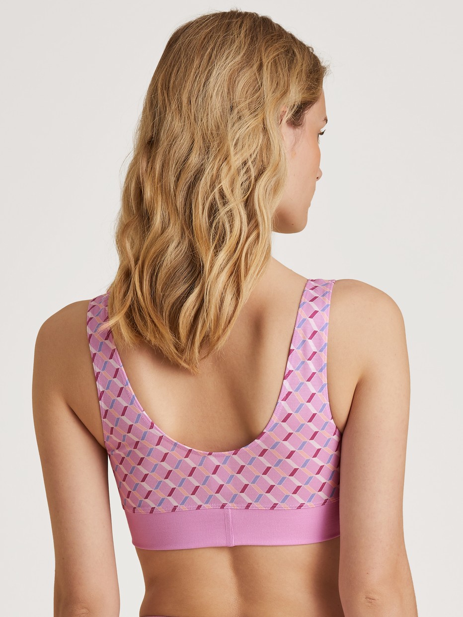 Damen-Model trägt Bustier mit Softbund aus Baumwolle in Rosa, Motiv aus Serie Elastic Trend von CALIDA, Rückansicht